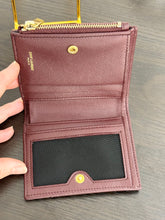 Load image into Gallery viewer, SAINT LAURENT Cassandre Matelasse Embossed Leather Bi-Fold Wallet in Burgundy
